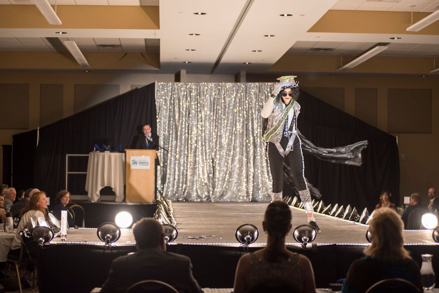 Fashion show runway event with model on stage
