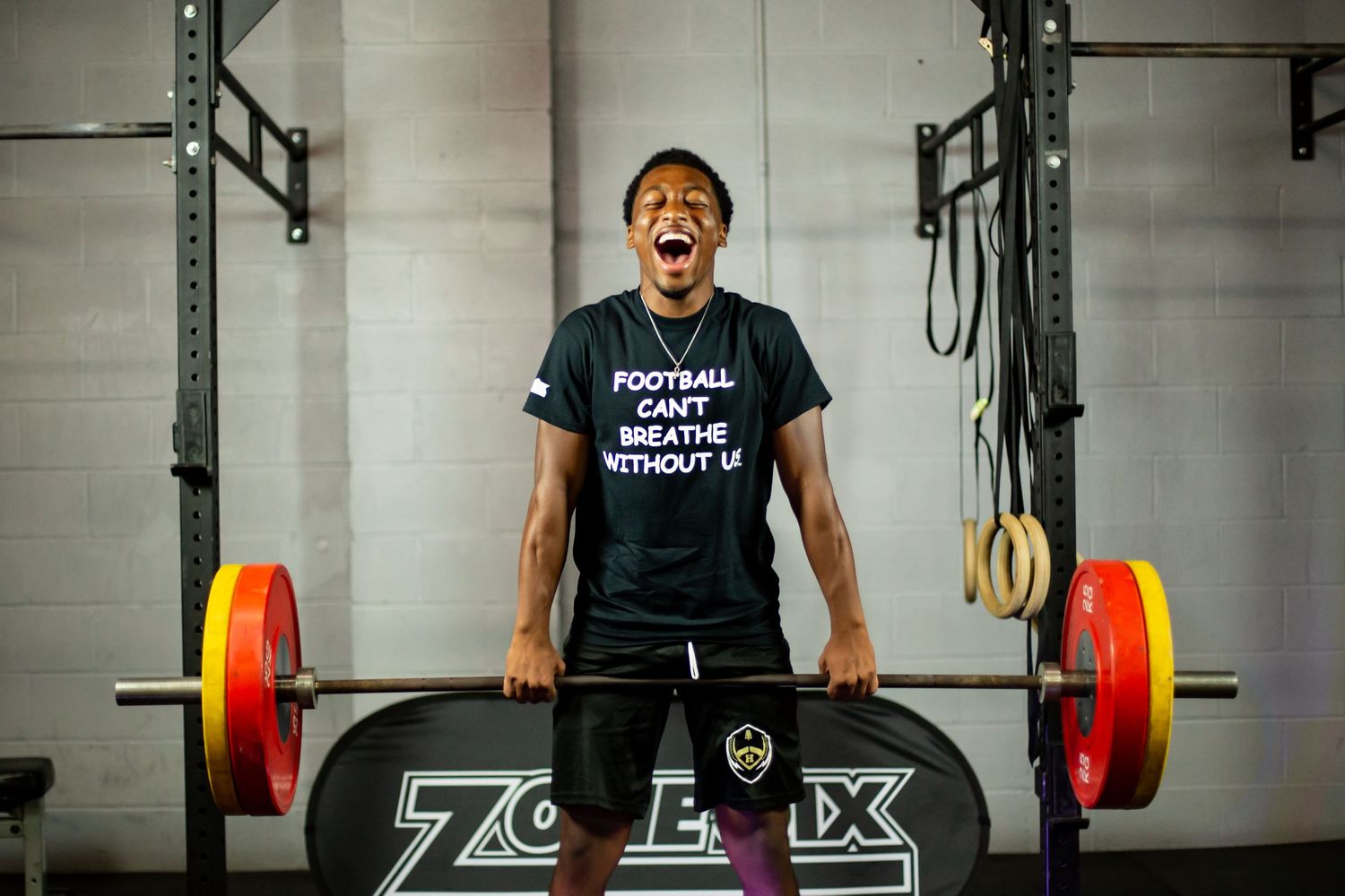 Zone Six crossfit weightlifter lifting heavy weights in gym.