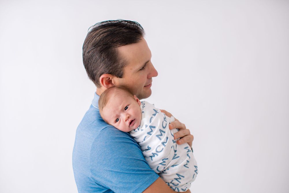 A tender moment captured between parent and baby during a professional studio photography session.