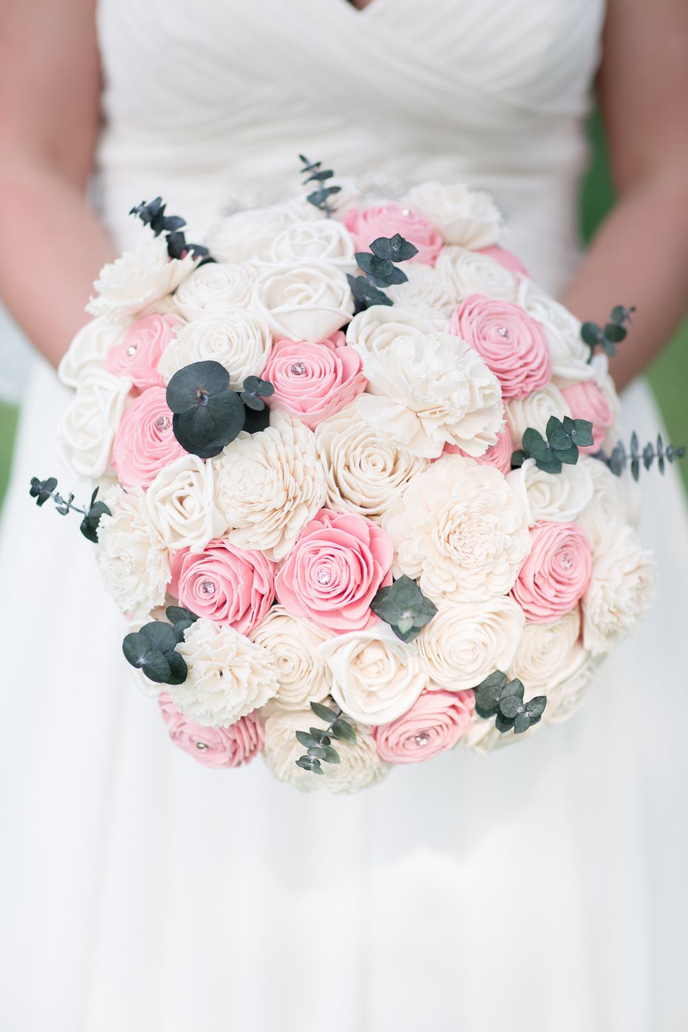 Elegant bridal bouquet featuring pink and white roses with eucalyptus accents.