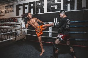 Sequence of martial arts kicks being performed in a boxing ring during practice.