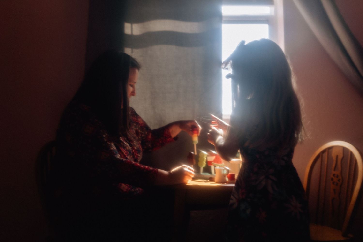mom and daughter playing tea party at their house in norfok, virginia