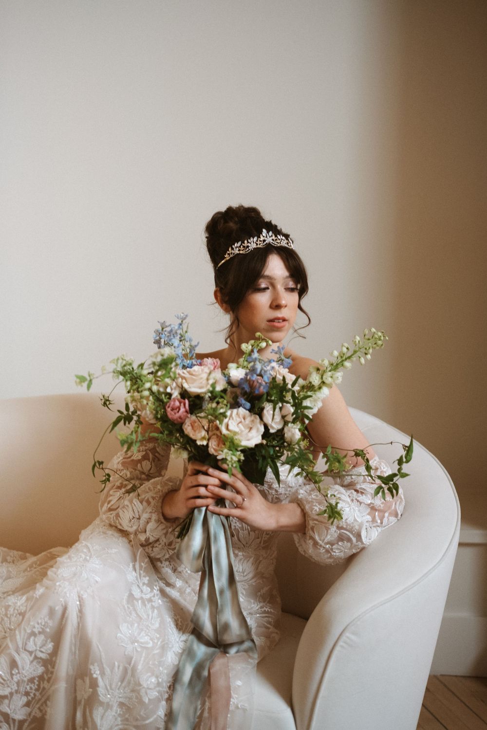 Elegant bridal portrait with delicate floral bouquet and lace details.