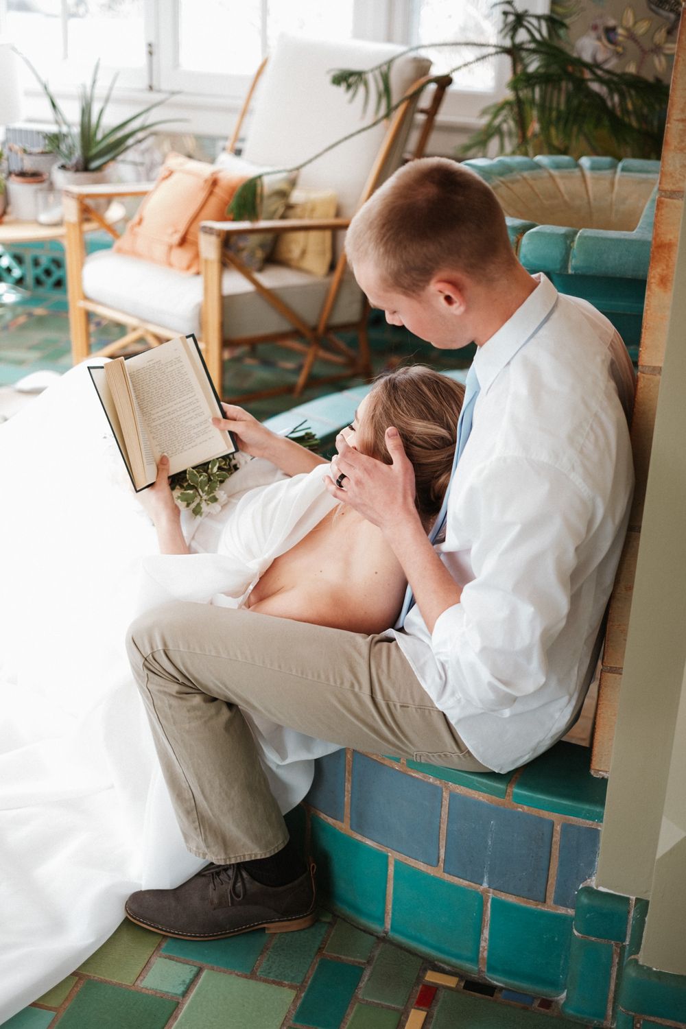 Intimate wedding couple moment on turquoise vintage furniture.
