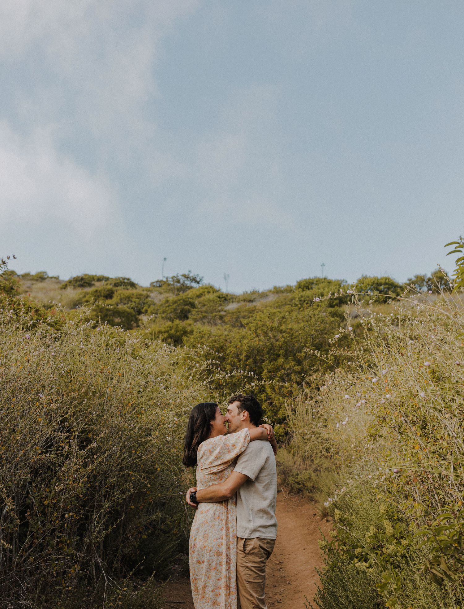 E. Noelle Photography couple engagement in the Los Angeles Malibu hills facing each other kissing intimately