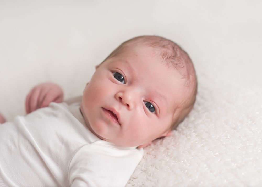 Beautiful newborn boy with open eyes