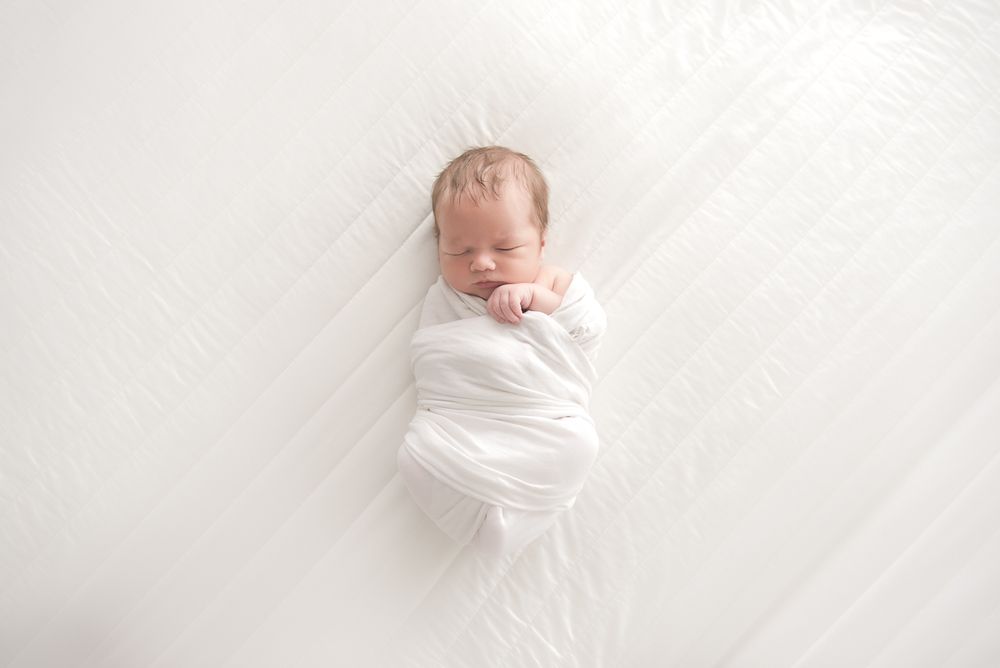 Newborn in swaddle wrap