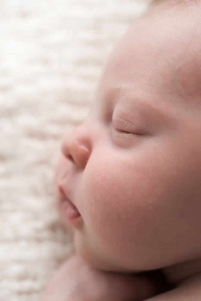 macro close up profile of newborn with chubby cheeks