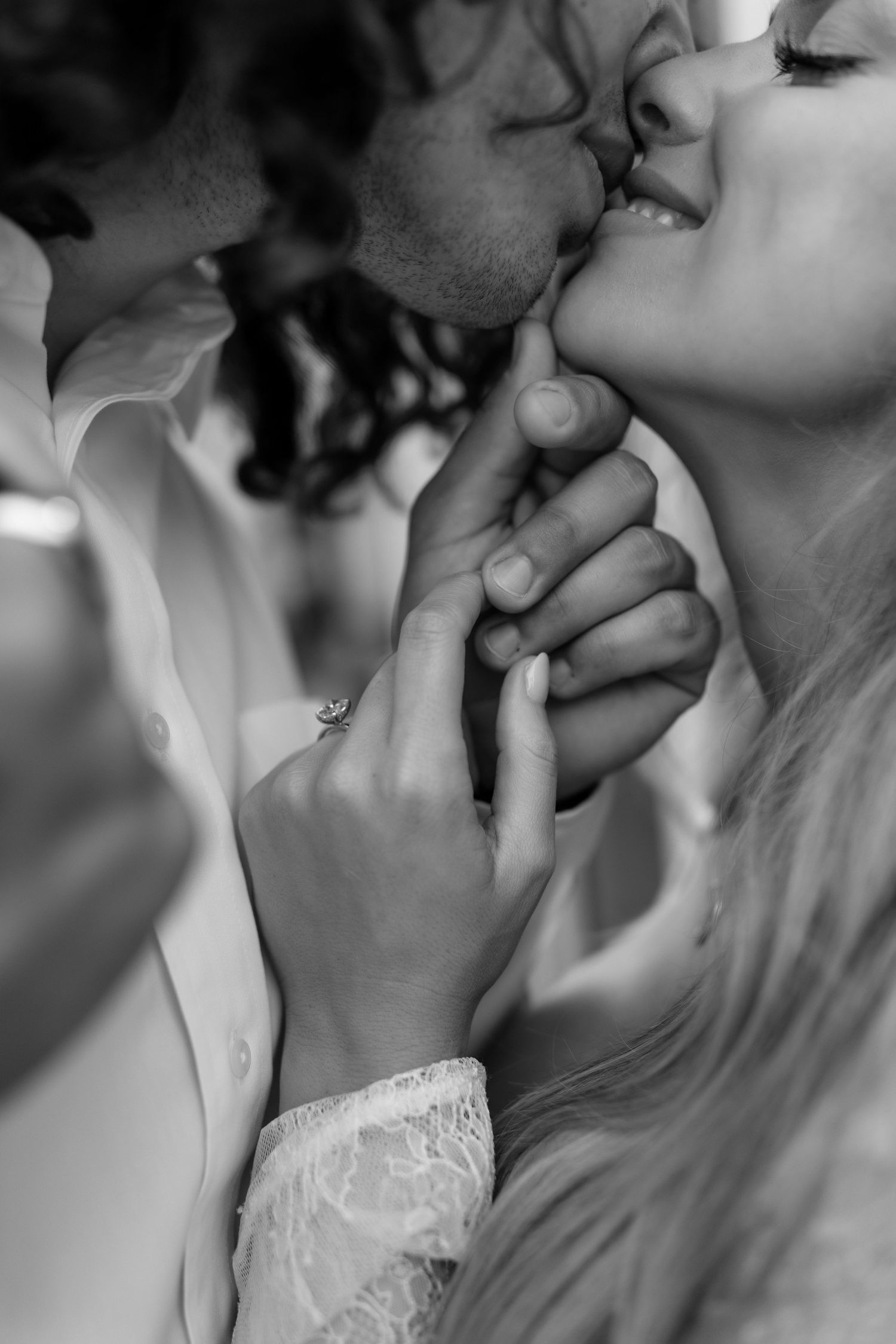 Romantic black and white close-up of couple's intimate embrace.