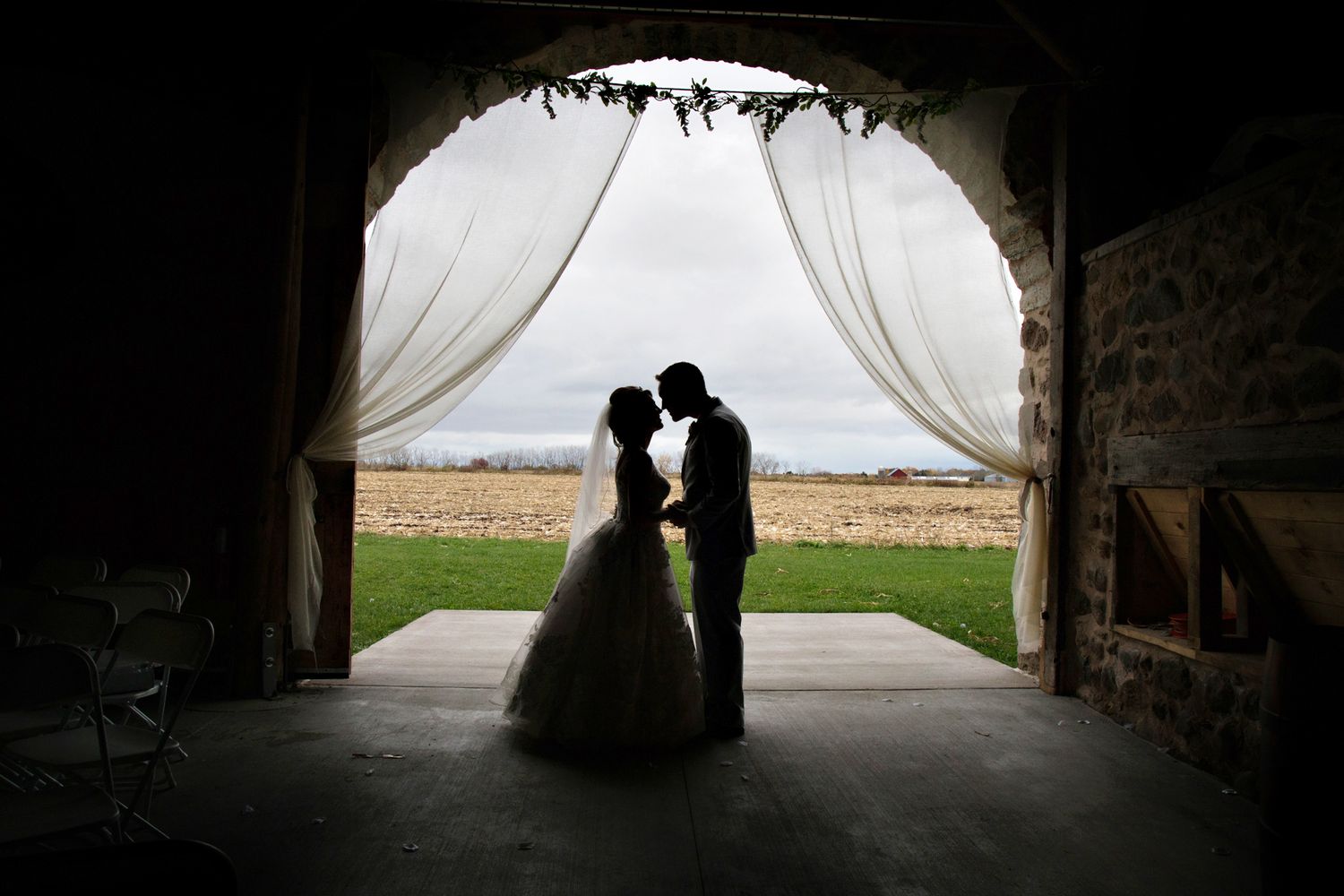 Silhouette of wedding couple in a barn ceremony in WI, by Rachel Moreau Photography.