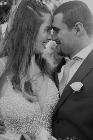 Black and white romantic portrait of newlyweds in an intimate moment during their wedding celebration.