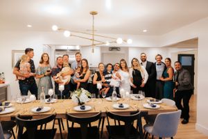 Wide view of wedding reception room with decorated tables and guests gathered.