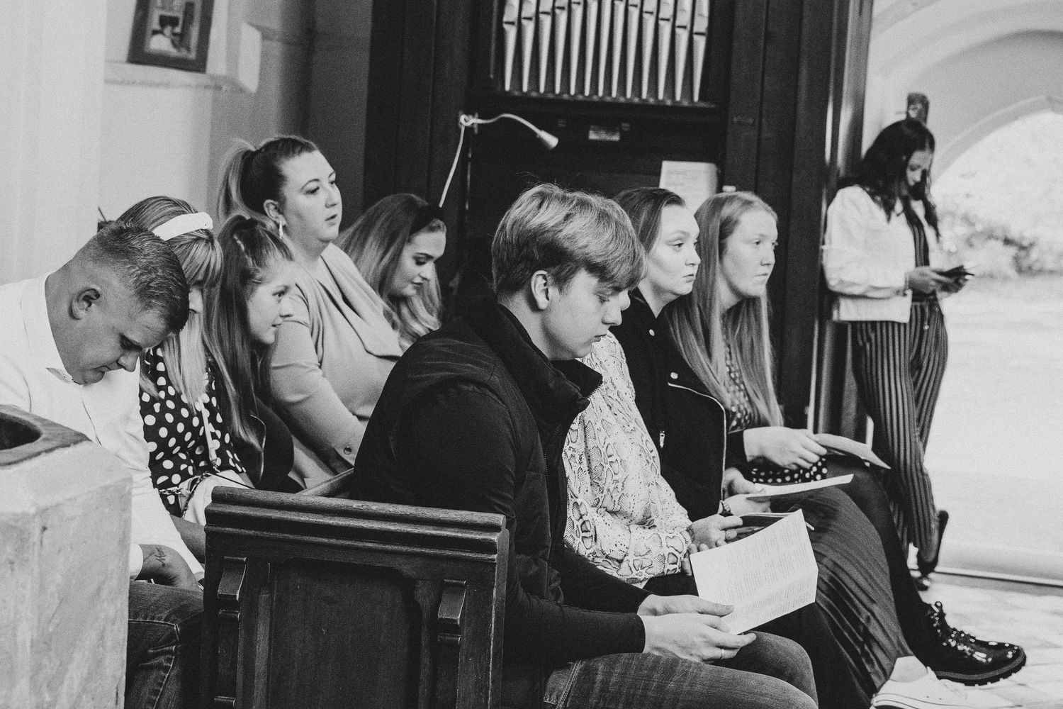 Congregation gathered in church pews during a religious service.