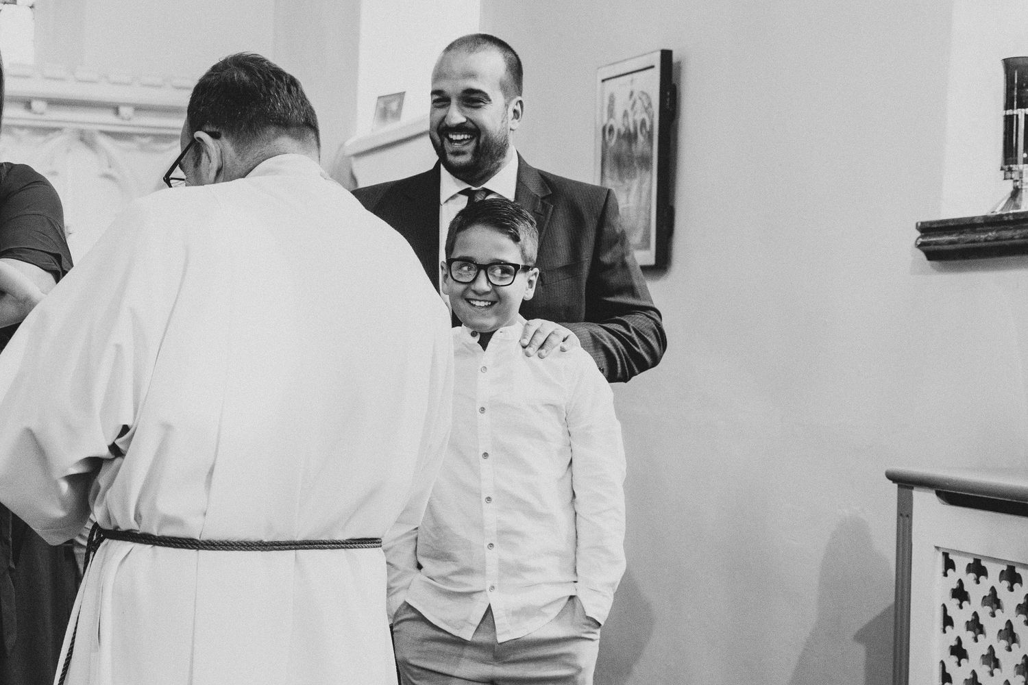 Black and white photo of a church gathering with people interacting after service.
