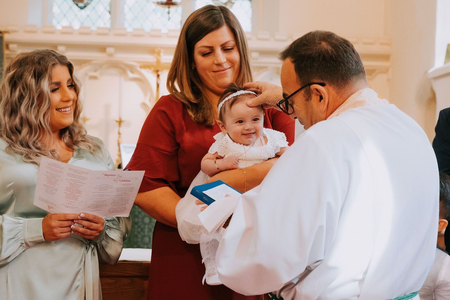 Religious ceremony taking place in a church with attendees participating.