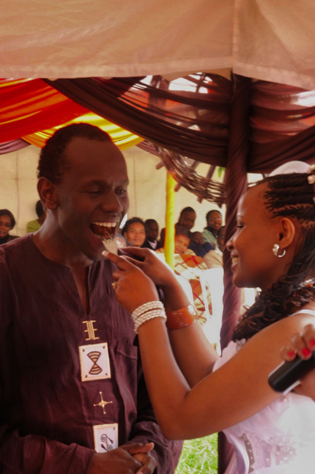 Kenyan bride and groom eating cake