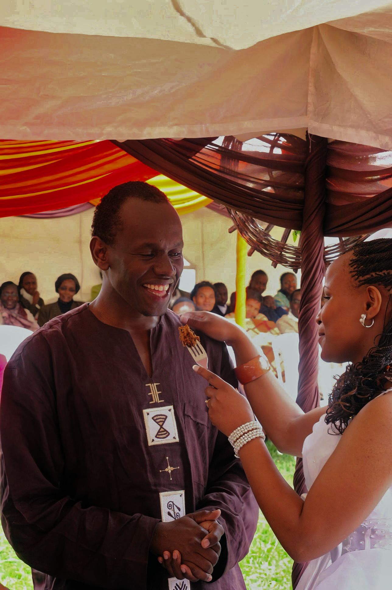 Kenyan bride and groom eating cake