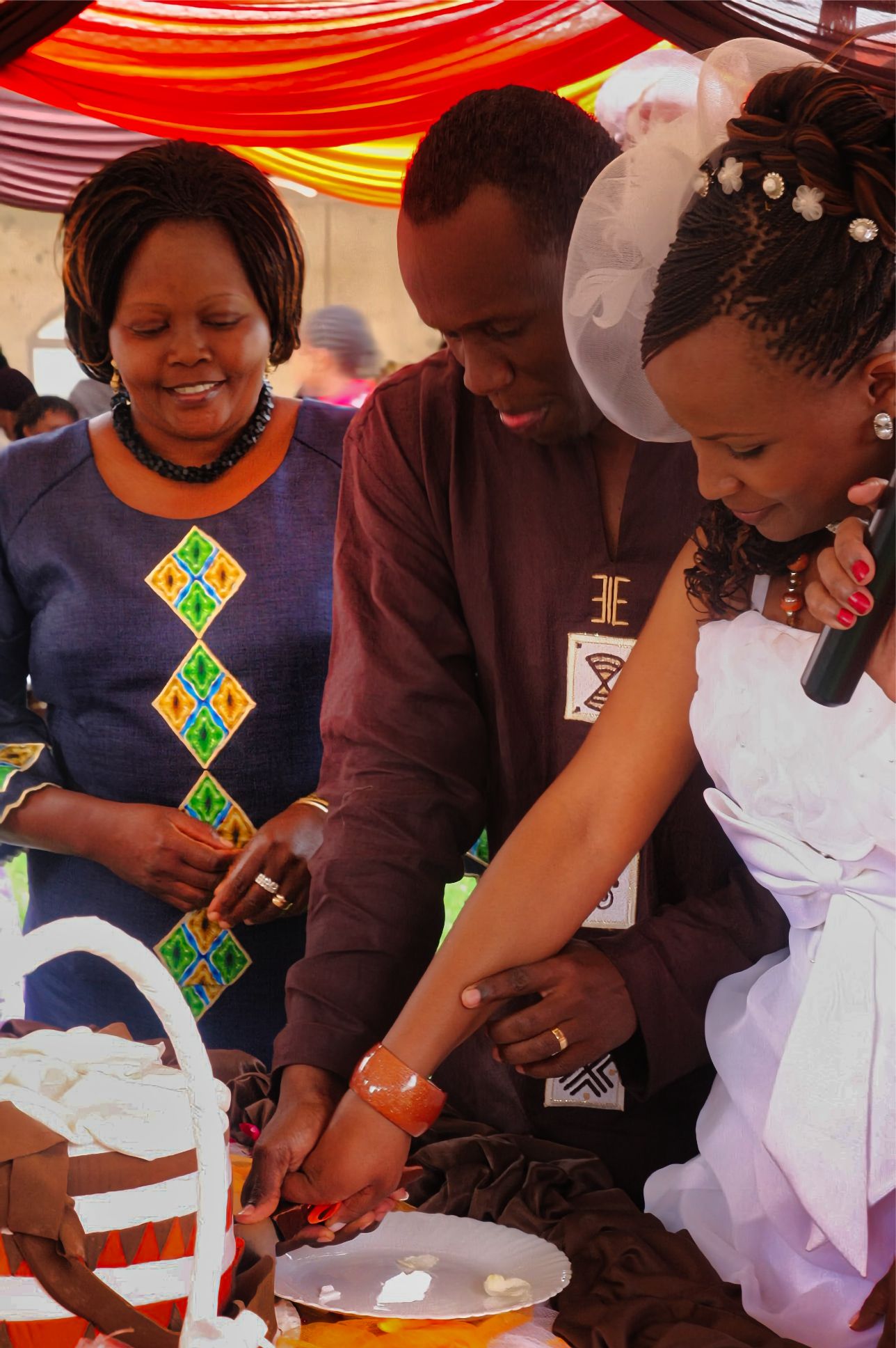 Kenyan bride and groom cutting cake
