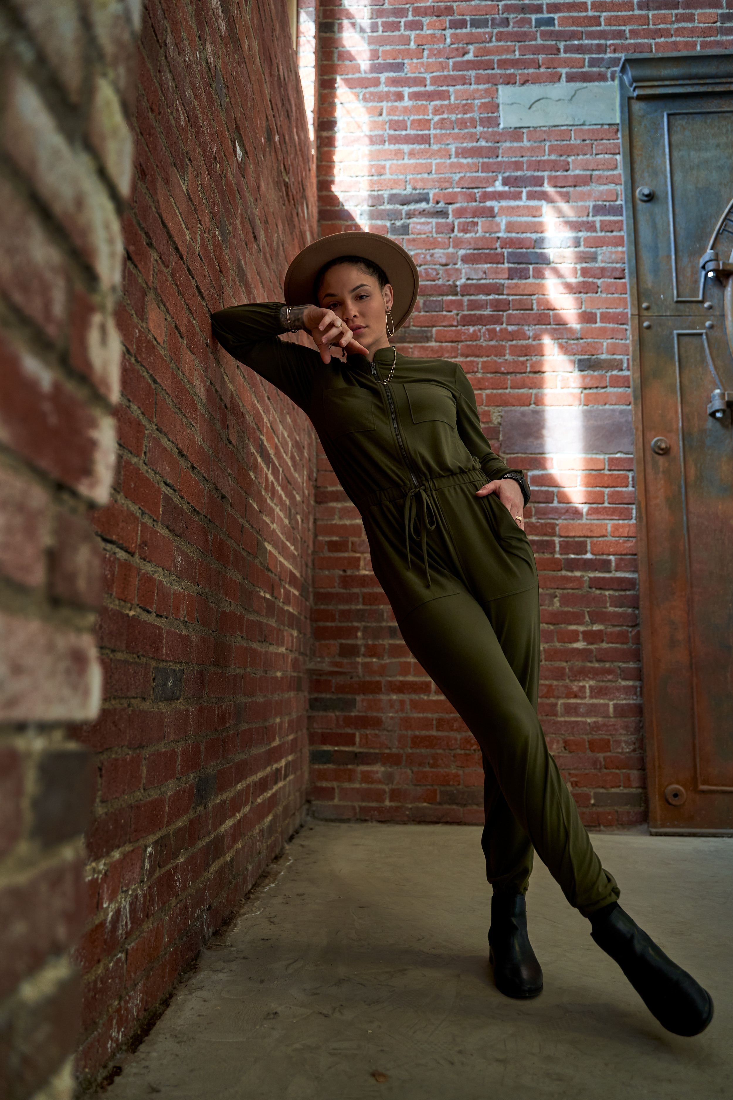 A sequence of playful poses against a brick wall showing dynamic movement and style.