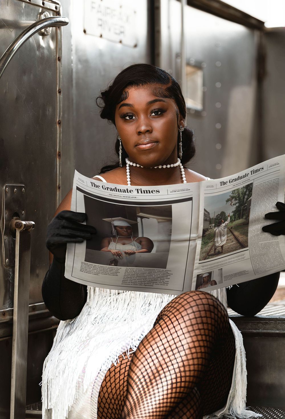 Glamorous portrait with vintage styling reading newspaper in formal attire.
