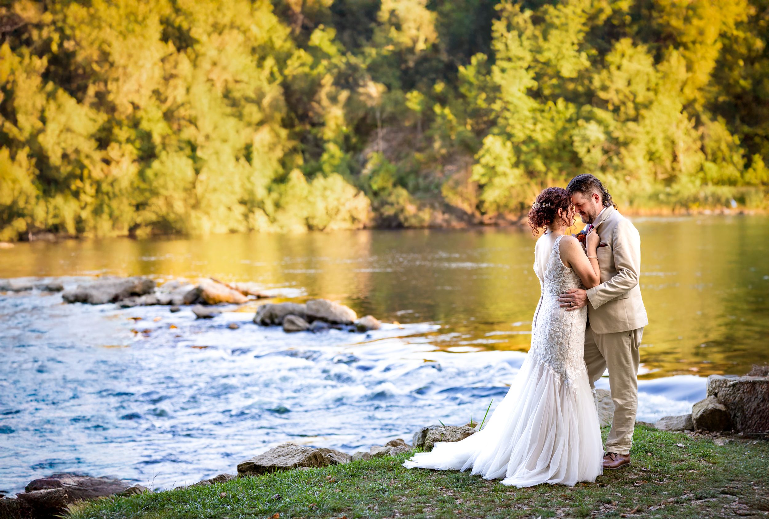 Bride and groom by the water at a riverside wedding near the Buffalo River in Arkansas