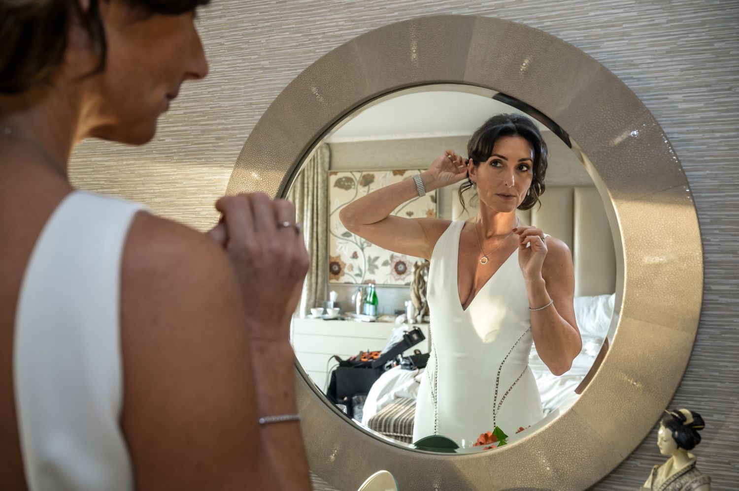 Bride looking in mirror at Gilpin Lake House