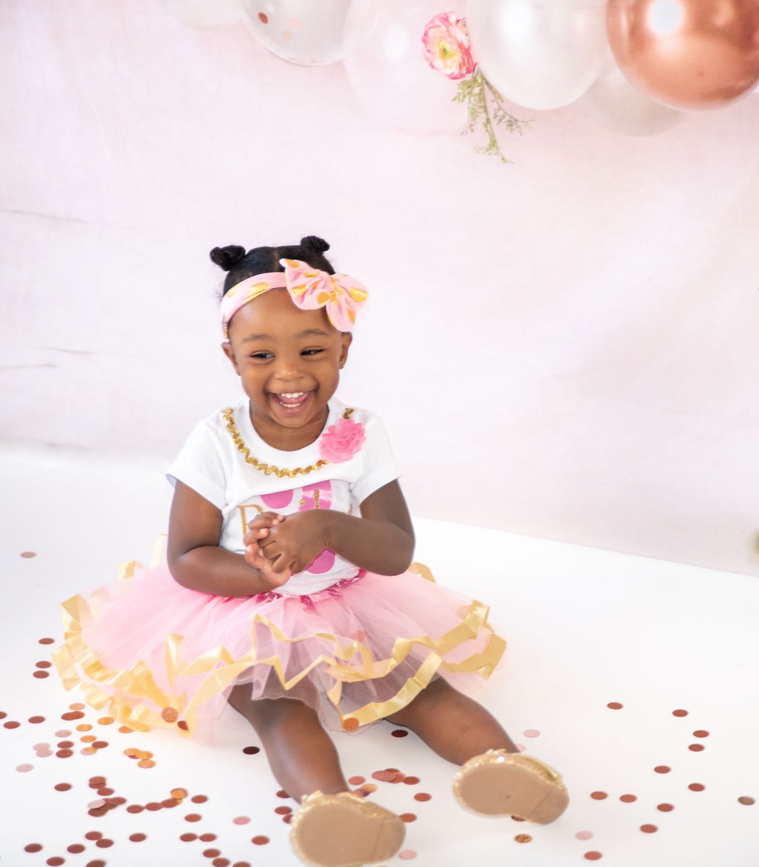 Festive birthday celebration setup with pink tulle dress and balloon decorations.