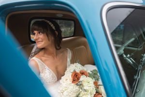 Classic blue vintage car used as wedding transportation.