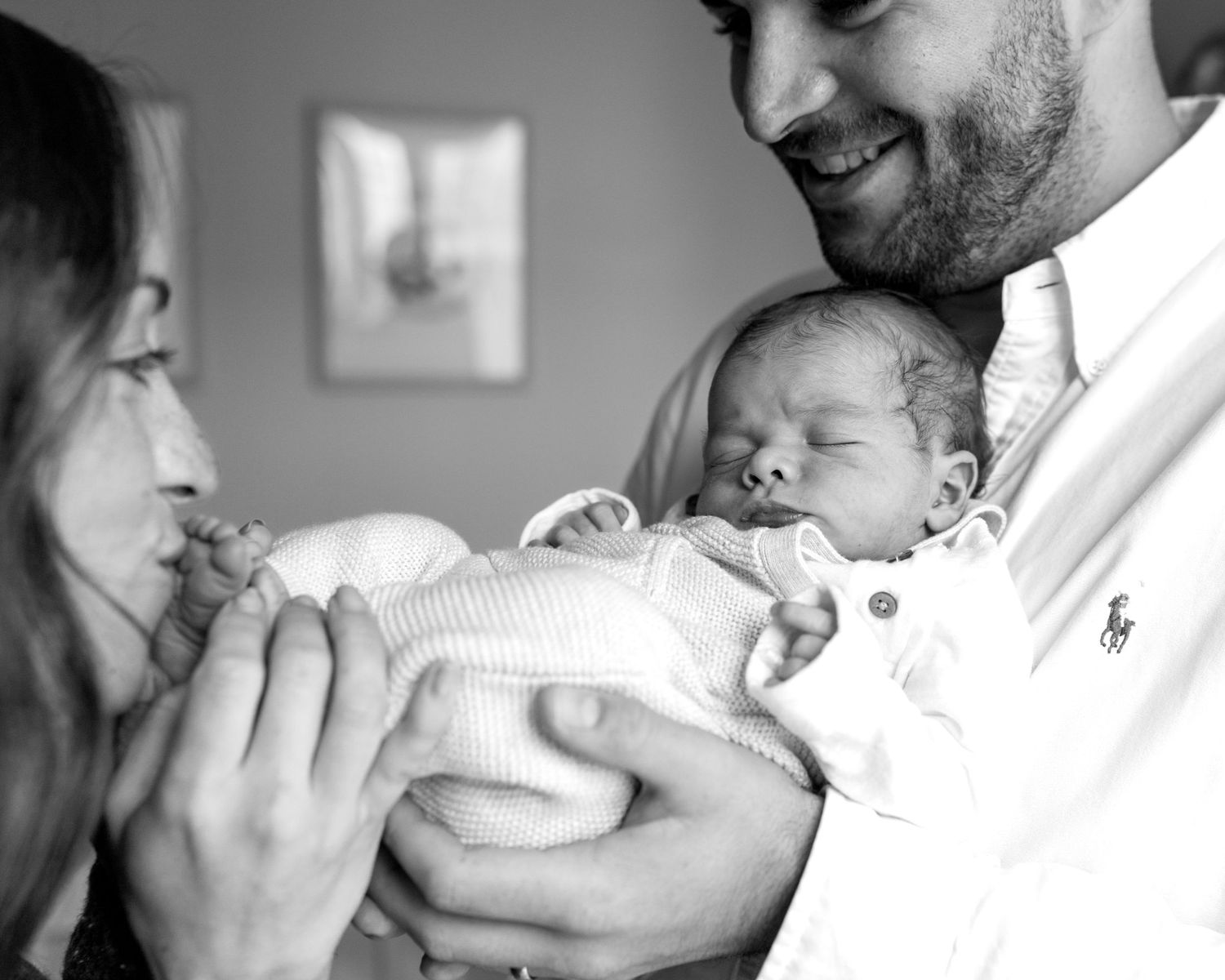 sleeping newborn in Lincoln Park IL with mom and dad kissing his toes. newborn poses