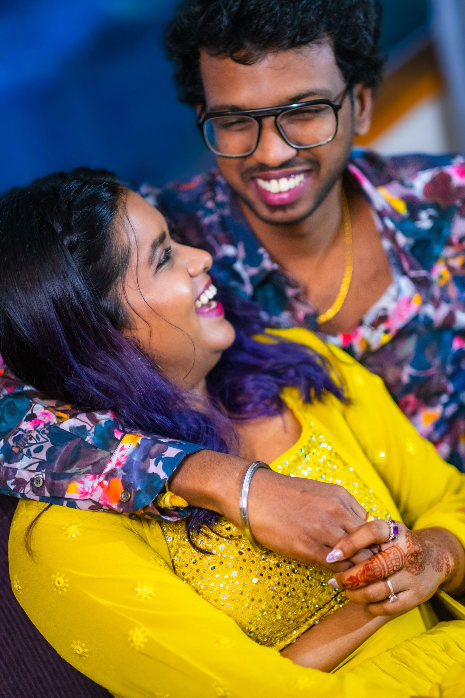 A couple sharing a tender moment while wearing festive attire at a celebration.