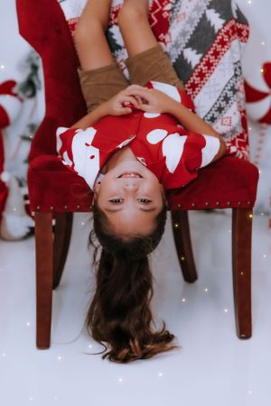 Playful holiday photo sequence with red and white outfits and festive decorations.