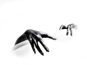 Artistic black and white hand gestures against white background.