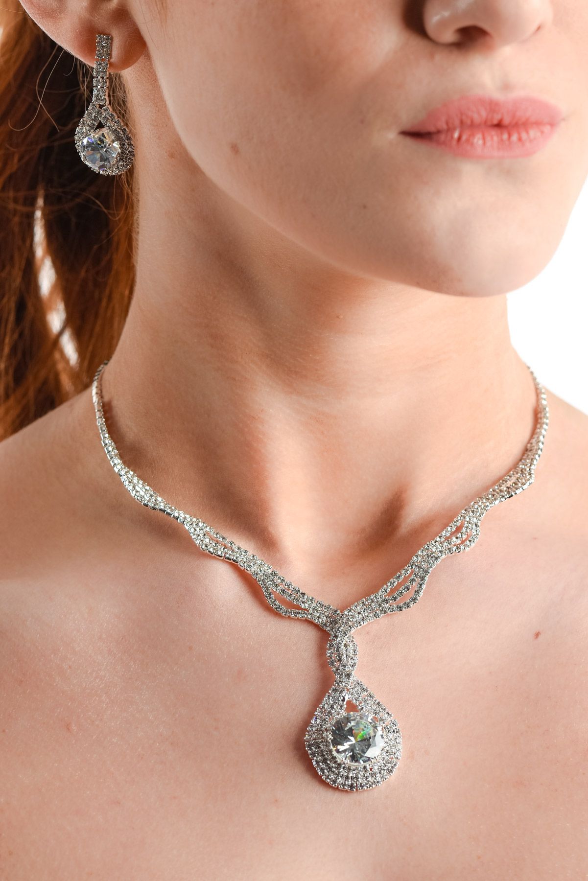 Elegant diamond necklace with intricate design displayed on model's neckline.