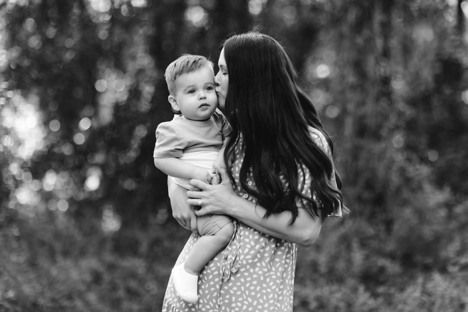 A tender moment between parent and child during an outdoor photo session.