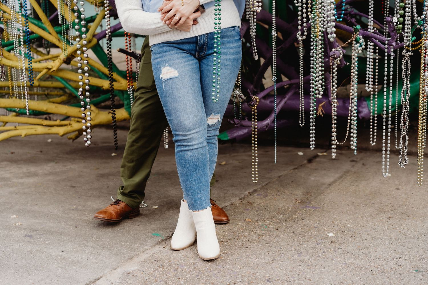 A couple embraces under a Mardi Gras tree in New Orleans.