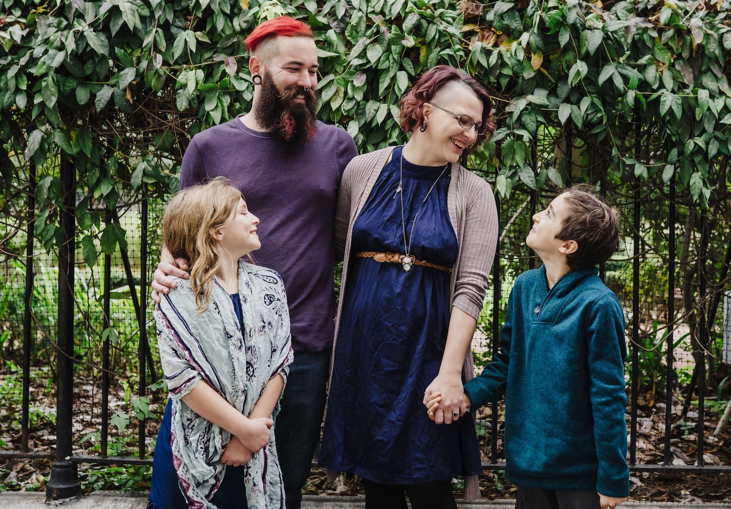 A family of four shares laughter together outside of the St. Louis Cathedral in New Orleans.