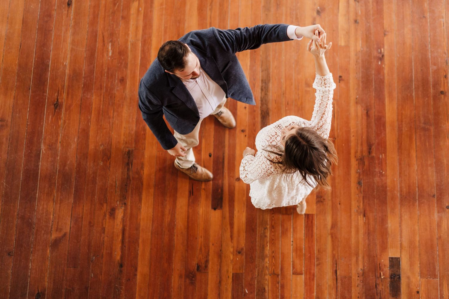 A couple dances below a balcony inside of Livaudas Hall in New Orleans.