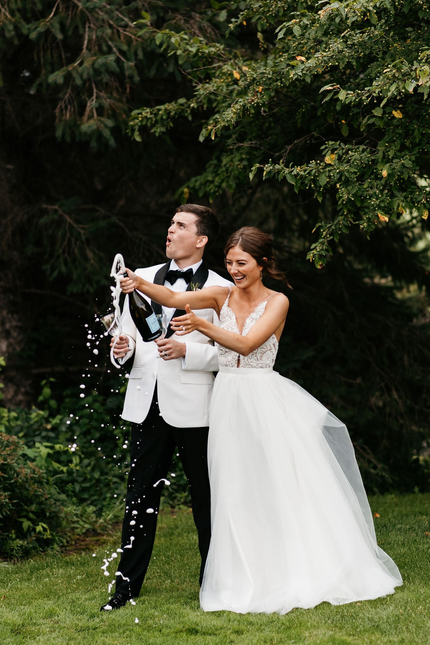 Sam and Whitney pop champagne at Royal Golf Club in Lake Elmo. Lindsay Miller Photography