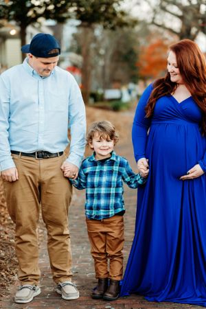 A family portrait series featuring a small child in plaid with parents in blue and khaki outfits.