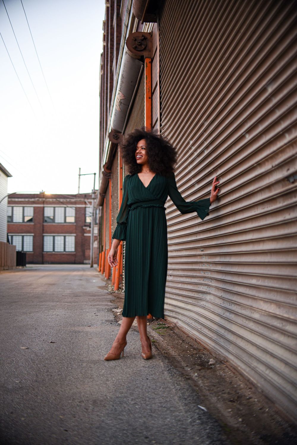 Fashion portrait series against industrial corrugated metal wall in urban setting.