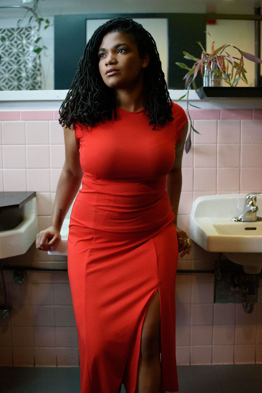 Fashion photography series featuring a vibrant red dress in bathroom setting.