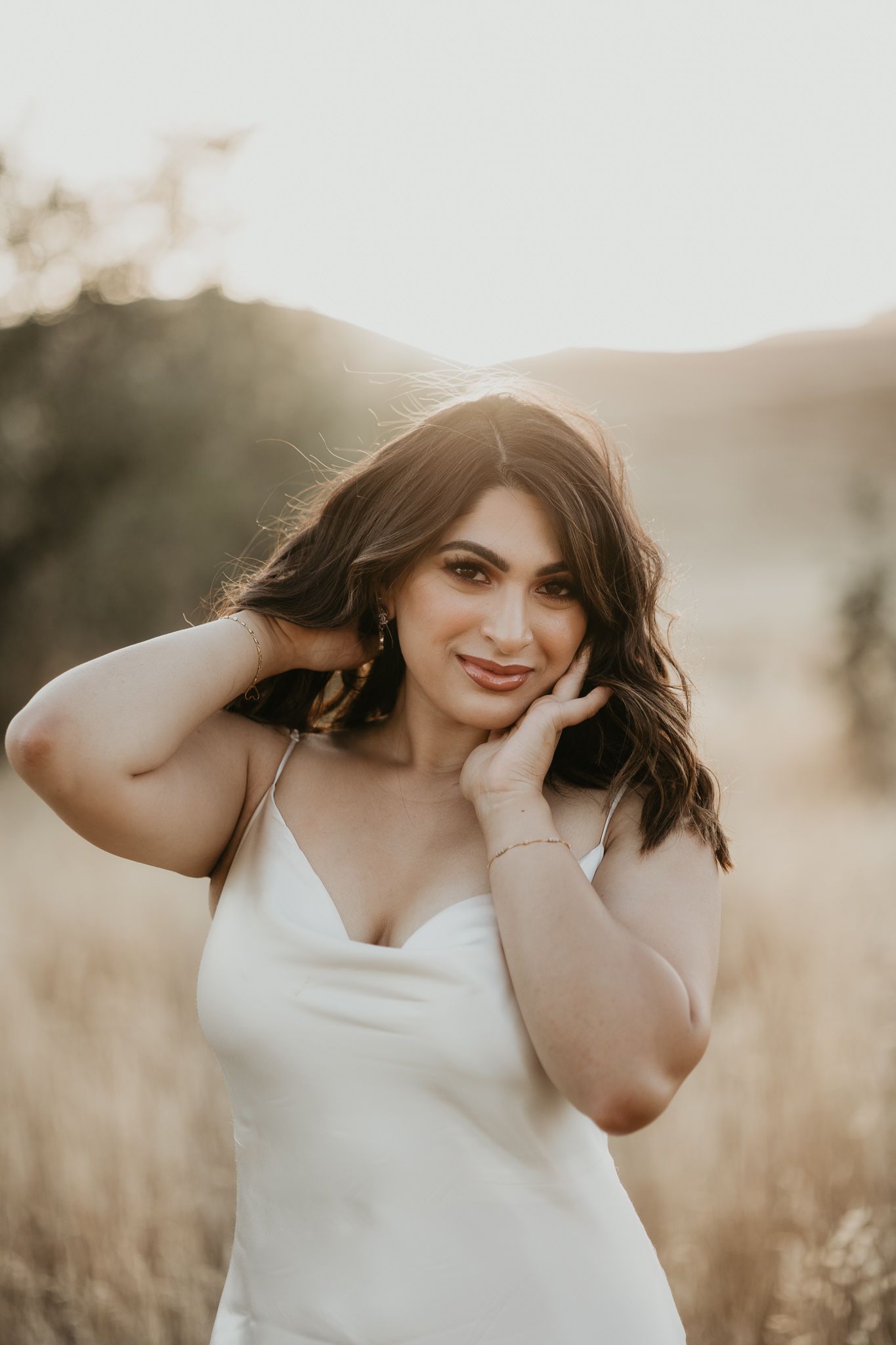 Beautiful outdoor portrait with warm lighting and natural expressions in a field setting.