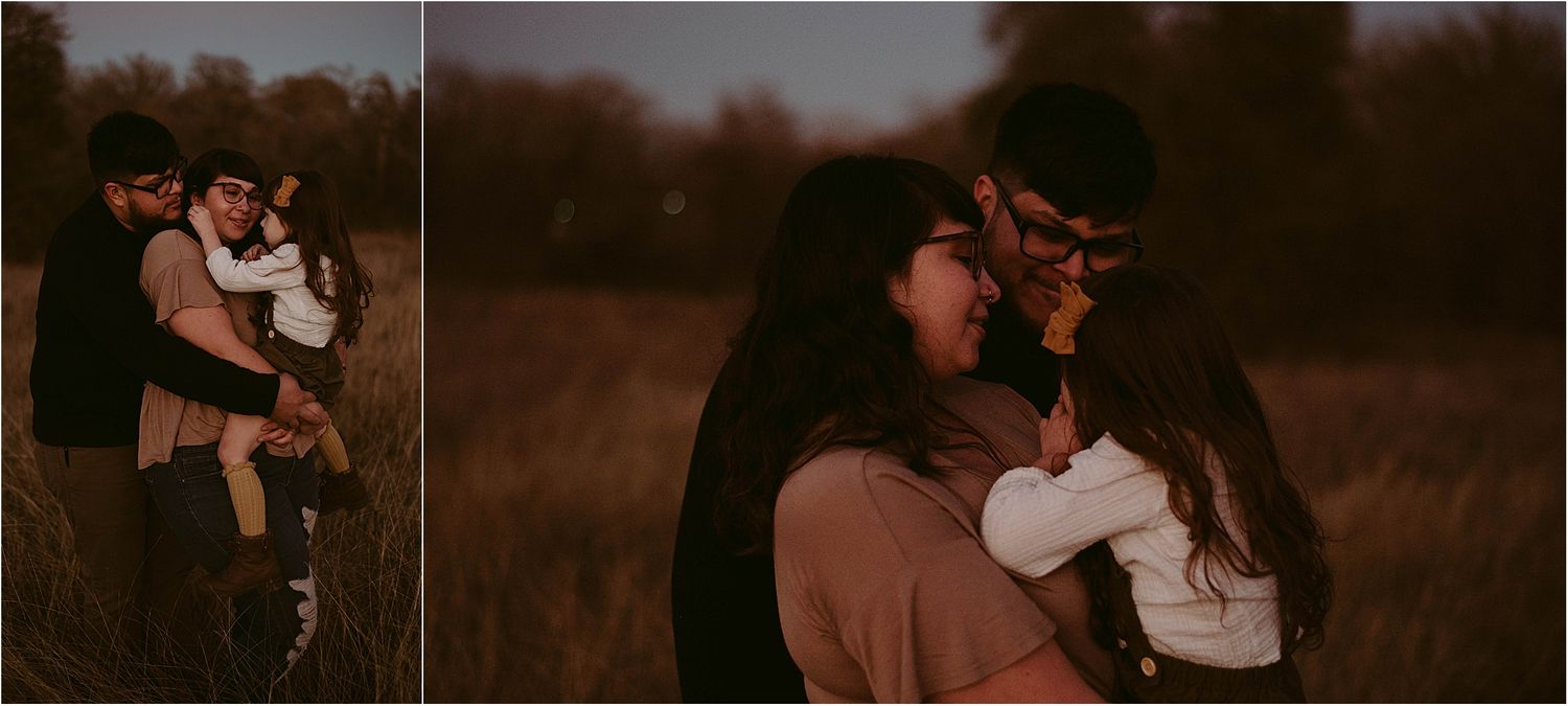 Intimate family moment captured in a rustic field at dusk.