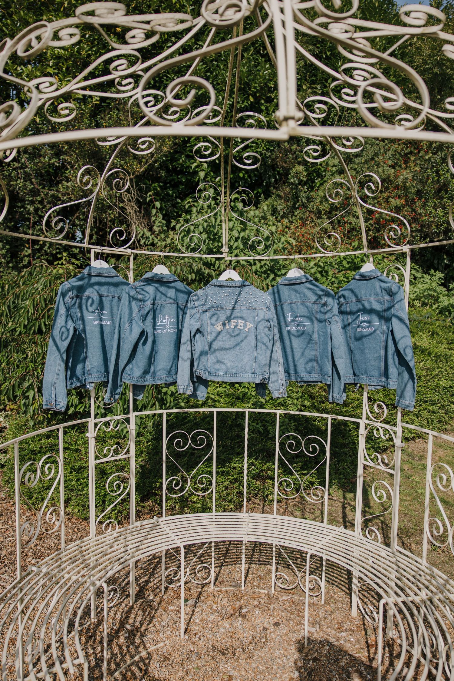customised denim jackets hung up at swallows oast wedding venue east sussex