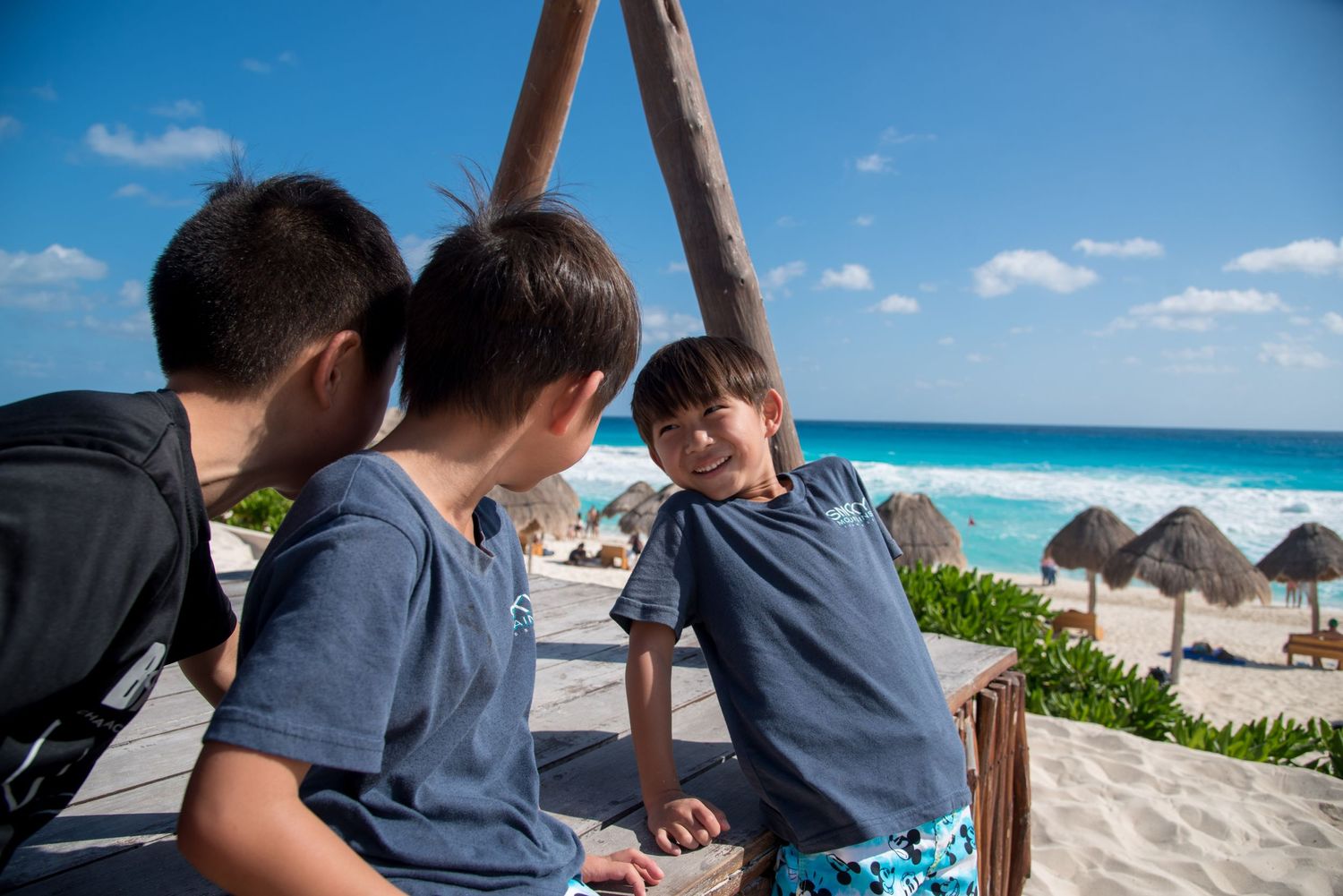 Candid shot of his children playing by the wooden structures