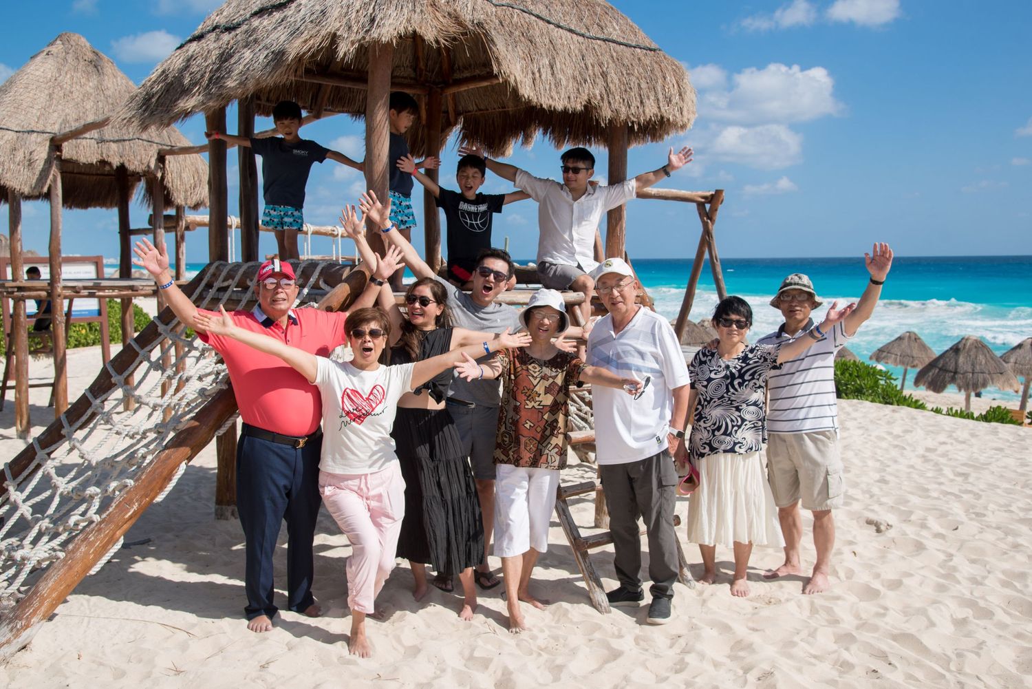 Eric's family posing together at Playa Delfines playground in Cancun