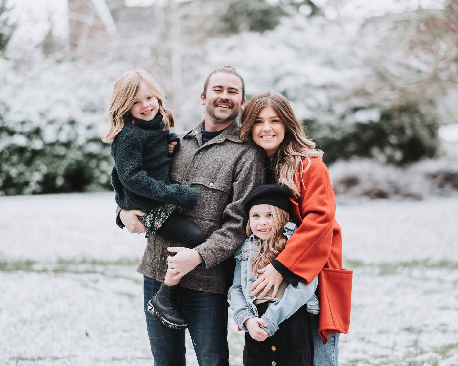 Snowy Family Portrait of Parents with their daughters on Christmas Eve
