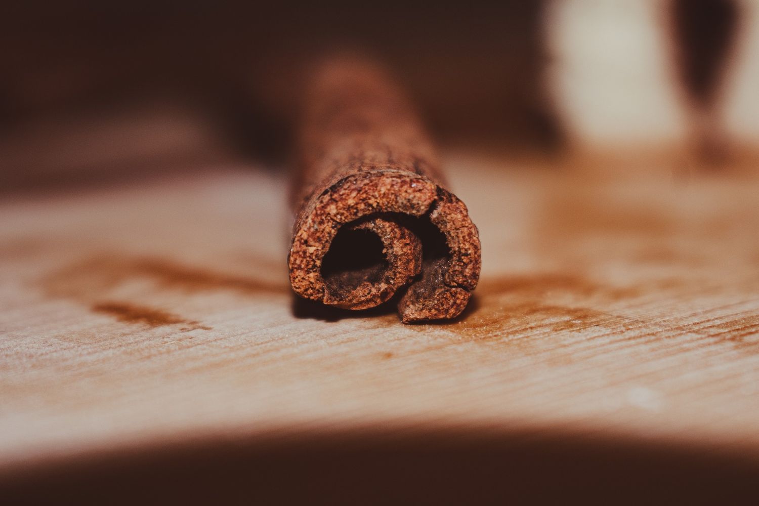 Close-up of chocolate pastry with swirled design on wooden surface.