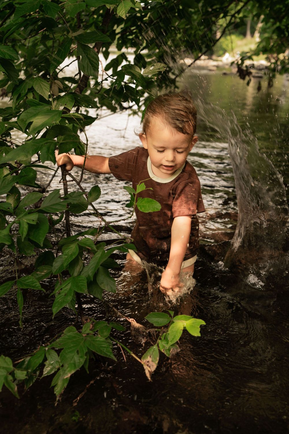 splashing toddler in river