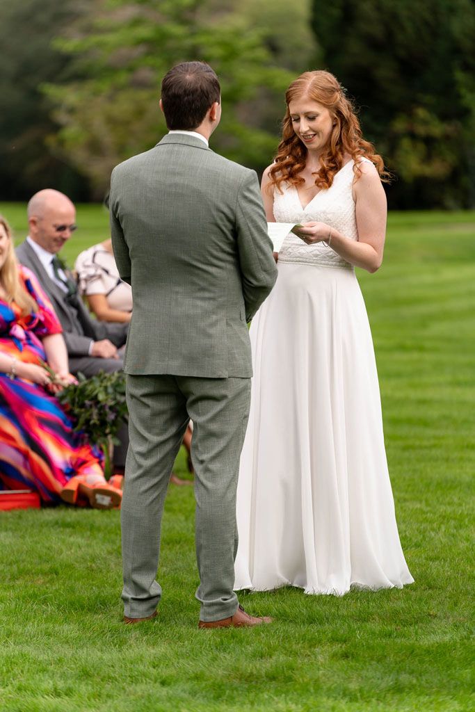 Bride & Groom saying vowels at Holne Park House outside ceremony in Devon.